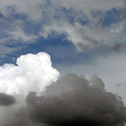 An image of white fluffy clouds in the sky